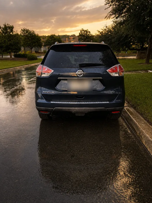 The blue Nissan SUV from behind