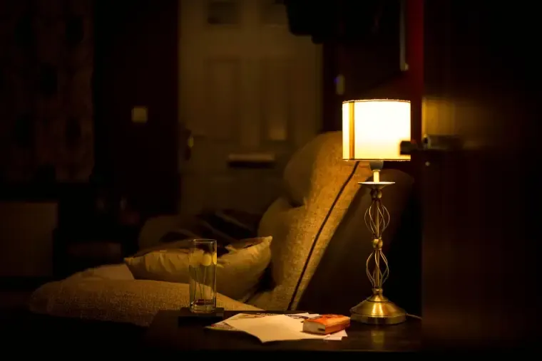 Lamp-lit armchair in a living room in the evening